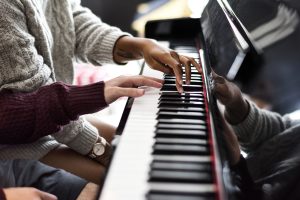 hands playing a beautiful piano melody together in 2026 03 18 09 54 31 utc